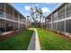 A beautiful and serene courtyard with lush green lawns and tall trees between condo buildings at 4725 Christa Ct # 331, Tampa, FL 33614