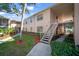 Charming condo exterior featuring manicured landscaping and exterior stairways at 4725 Christa Ct # 331, Tampa, FL 33614