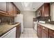Traditional kitchen with granite countertops, white appliances, and warm wood cabinetry at 4725 Christa Ct # 331, Tampa, FL 33614