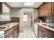 Open kitchen design with stone counters, tiled flooring, and wood cabinets at 4725 Christa Ct # 331, Tampa, FL 33614