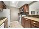 Updated kitchen featuring stainless steel microwave, granite counters, and wood cabinets at 4725 Christa Ct # 331, Tampa, FL 33614