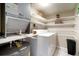 Functional laundry area with modern appliances, shelving, and ample storage for convenience at 4725 Christa Ct # 331, Tampa, FL 33614