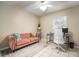 Cozy space with natural light, pink couch, ceiling fan and tile floors, suitable for relaxation at 4725 Christa Ct # 331, Tampa, FL 33614