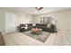 Spacious living room featuring a large sectional sofa, tile floors, and natural light at 4725 Christa Ct # 331, Tampa, FL 33614