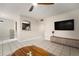 Open concept living space featuring tile flooring, a large TV, and access to the kitchen at 4725 Christa Ct # 331, Tampa, FL 33614