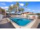 Enjoy this bright, sunny community pool surrounded by white fence, brick pavers, and tropical trees at 4725 Christa Ct # 331, Tampa, FL 33614