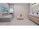 Modern bathroom with double sinks, a freestanding tub and a walk-in shower at 513 Hand Ave, Sarasota, FL 34232