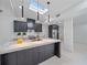 Modern kitchen with a large island, quartz countertops, and black cabinets at 513 Hand Ave, Sarasota, FL 34232