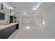 Open concept kitchen with island and view into living and dining areas at 513 Hand Ave, Sarasota, FL 34232