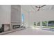 Bright living area with a large concrete fireplace, sliding glass doors, and hardwood floors at 513 Hand Ave, Sarasota, FL 34232