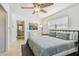 Bright bedroom featuring a comfortable queen bed, fan, and a bathroom entrance at 6721 30Th S St, St Petersburg, FL 33712