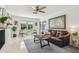 Bright living room featuring a large world map, plush sofa, and a view to the backyard at 6721 30Th S St, St Petersburg, FL 33712