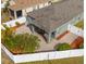 Aerial view of a fenced backyard with a paved patio, palm trees, and landscaping at 7241 Forest Mere Dr, Riverview, FL 33578