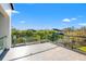 Private balcony with glass railings and views of lush landscaping at 730 W Alda Ne Way, St Petersburg, FL 33704