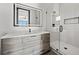 Elegant bathroom with a floating vanity, frameless glass shower, and LED mirror at 730 W Alda Ne Way, St Petersburg, FL 33704