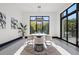 Bright dining room with modern table and chairs, large windows, and stylish light fixture at 730 W Alda Ne Way, St Petersburg, FL 33704