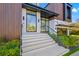 Modern front entrance with glass railings and stone steps at 730 W Alda Ne Way, St Petersburg, FL 33704