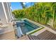 Modern pool and spa with glass railings and wooden deck at 730 W Alda Ne Way, St Petersburg, FL 33704