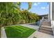 Modern pool and spa with a grassy backyard and palm trees at 730 W Alda Ne Way, St Petersburg, FL 33704