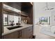 Stylish wet bar with sink, shelving, and access to bedroom at 730 W Alda Ne Way, St Petersburg, FL 33704