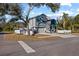 Two-story house with gray and blue exterior, and a white fence. Side yard view at 7321 Mount Vernon Rd, Tampa, FL 33625