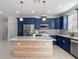 Modern kitchen with blue cabinets, quartz countertops and a center island at 7321 Mount Vernon Rd, Tampa, FL 33625