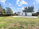 Spacious backyard with large grassy area and concrete patio at 8719 92Nd Ter, Seminole, FL 33777