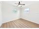 Well-lit bedroom featuring wood-look floors and a ceiling fan at 8719 92Nd Ter, Seminole, FL 33777