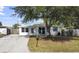 Newly renovated home with a carport and well-manicured lawn at 8719 92Nd Ter, Seminole, FL 33777