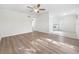 Open living room with kitchen access and hardwood floors at 8719 92Nd Ter, Seminole, FL 33777