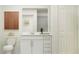 Clean bathroom with white vanity, toilet and large mirror at 10206 Alder Green Dr, Riverview, FL 33578