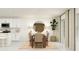 Modern kitchen with white cabinets, island, and dining area at 10206 Alder Green Dr, Riverview, FL 33578