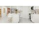 Modern kitchen with white cabinets, island, and breakfast bar at 10206 Alder Green Dr, Riverview, FL 33578