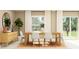Modern dining room with a wooden table and white chairs at 10264 Alder Green Dr, Riverview, FL 33578