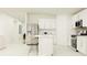 Bright kitchen boasts white cabinets, stainless steel appliances, and an island at 10264 Alder Green Dr, Riverview, FL 33578