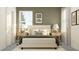 Bedroom with a green accent wall and white bedding at 11729 71St E Ave, Palmetto, FL 34221