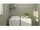 Laundry room with washer and dryer, and overhead shelving at 11729 71St E Ave, Palmetto, FL 34221