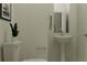 Stylish bathroom featuring a pedestal sink and toilet at 11555 E 71St Ter, Palmetto, FL 34221
