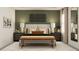 Serene bedroom with a king-size bed and green accent wall at 11555 E 71St Ter, Palmetto, FL 34221