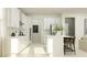 White kitchen with island and stainless steel appliances at 11555 E 71St Ter, Palmetto, FL 34221