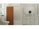 Bathroom with a tub shower, white vanity, and orange curtain at 11562 E 71St Ter, Palmetto, FL 34221