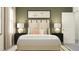 Bedroom with a light beige upholstered bed and side tables at 11562 E 71St Ter, Palmetto, FL 34221