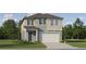 Two-story house with neutral siding, gray roof, and a two-car garage at 11562 E 71St Ter, Palmetto, FL 34221