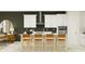 Modern kitchen with white cabinets, an island with seating, and a statement wall at 11562 E 71St Ter, Palmetto, FL 34221