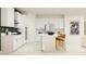 Modern kitchen with white cabinets, an island, and stainless steel appliances at 11562 E 71St Ter, Palmetto, FL 34221
