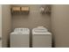 Convenient laundry room with washer, dryer, and overhead shelving at 11562 E 71St Ter, Palmetto, FL 34221