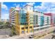 Modern multi-story building with yellow and red accents, ample parking, and city views at 1208 E Kennedy Blvd # 729, Tampa, FL 33602