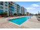 Community pool with plenty of lounge chairs and building views at 1208 E Kennedy Blvd # 729, Tampa, FL 33602