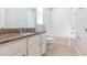 Bathroom with granite countertop, white cabinets, and a bathtub at 12312 Bay Estuary Bnd, Riverview, FL 33579