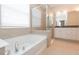 Bathroom with soaking tub and walk-in shower at 12312 Bay Estuary Bnd, Riverview, FL 33579